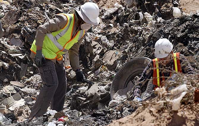 In this April 26, 2014 file photo, workers sift through trash in search for decades-old Atari 'E.T. the Extra-Terrestrial' game cartridges in Alamogordo, N.M.