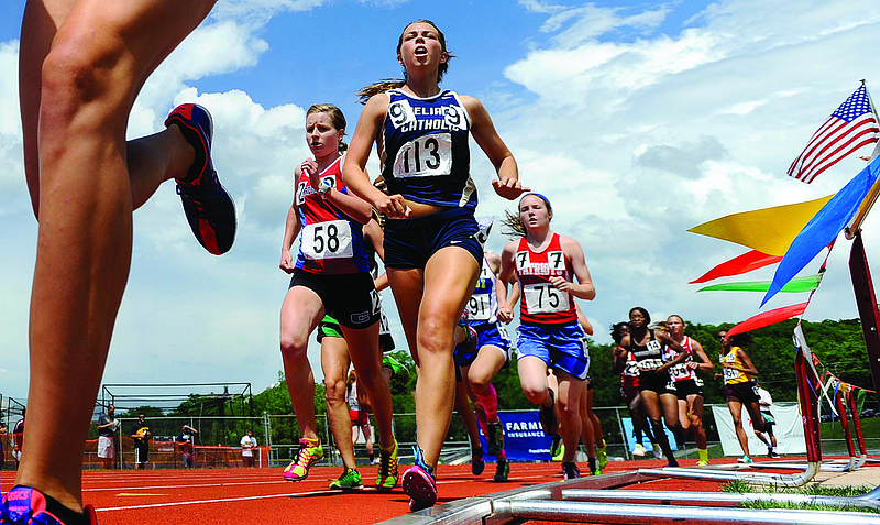 Helias' Kaitlyn Shea (113) hugs the inside rail during the Class 3 girls 1,600-meter run Friday at Dwight T. Reed Stadium in the MSHSAA Track and Field Championships.