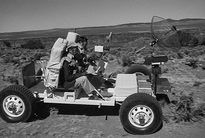 This 1971 image provided by NASA shows Apollo 17 astronauts, Harrison "Jack" Schmitt, left, and an unidentified man, training with the lunar roving vehicle on the Big Island of Hawaii. Before many Apollo astronauts went to the moon, they came to Hawaii to train on the Big Island's lunar landscapes. Now, decades-old photos are surfacing of astronauts scooping up Hawaii's soil and riding across volcanic fields in a "moon buggy" vehicle.