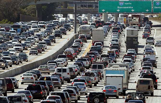 This May 28, 2010, file photo shows traffic jammed in both directions on Interstate 405 on the Westside of Los Angeles. With people driving more fuel efficient cars and fewer miles some states are pondering the question of how to pay for roads funded largely with gas taxes, and many are watching Oregon's test of a tax on miles traveled.