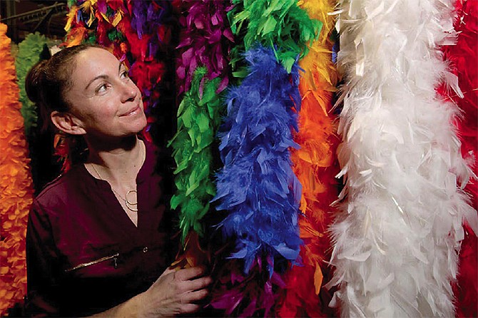 Abby Arauz, owner of The Feather Place, stands with some of her boas. She dyes and creates feather art for Victoria's Secret, Lady Gaga, BeyoncÃ© and others.