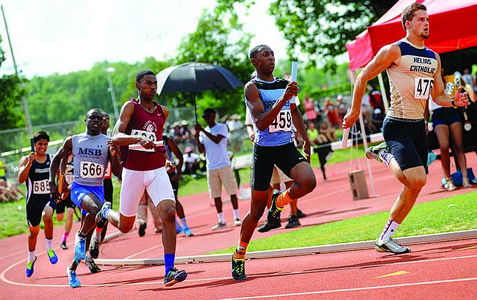 Second-leg runners give chase to Helias' J.C. Szumigala as they round the turn and sprint onto the front straightaway while competing in the MSHSAA Class 3 boys 4x400-meter relay Saturday at Dwight T. Reed Stadium in Jefferson City.