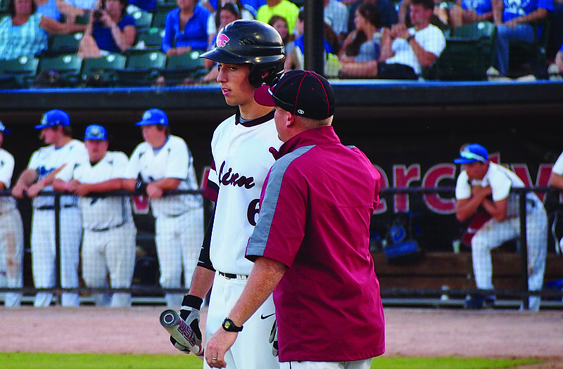 Linn coach Colby Nilges talks to Ben Klebba during a break in an at-bat Monday in O'Fallon.