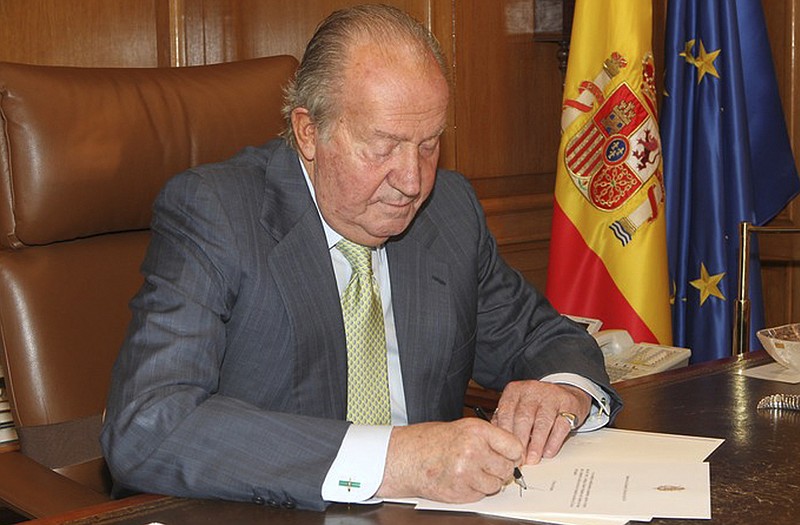 Spain's King Juan Carlos signs a document in the Zarzuela Palace opening the way for his abdication. Spain's King Juan Carlos plans to abdicate and pave the way for his son, Crown Prince Felipe, to take over, Spanish Prime Minister Mariano Rajoy told the country Monday in an announcement broadcast nationwide. 