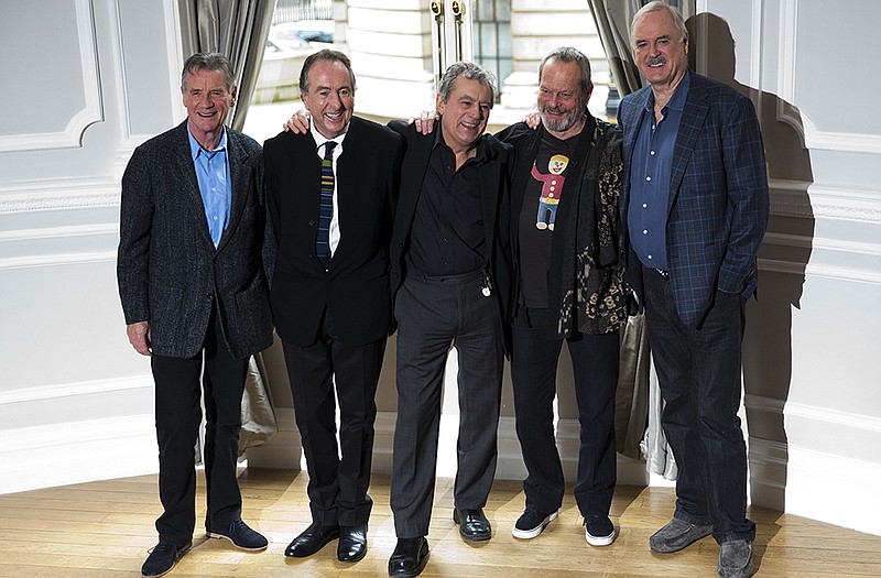 Surviving members of the Monty Python comedy group, from left, Michael Palin, Eric Idle, Terry Jones, Terry Gilliam and John Cleese pose for photographers during a photocall to promote a reunion stage show they are going to perform together in London. It will be screened in hundreds of U.S. theaters.