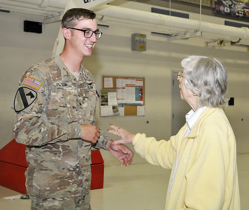 Sgt. Alex Flynn is greeted by his grandmother, Mrs. Harold Flynn, both of Fulton, during a brief ceremony to welcome home returning members of the 70th Mobile Public Affairs Detachment held Tuesday at Missouri National Guard Headquarters. Since being mobilized in July of last year, Flynn has reached the rank of sergeant and won second place in the Military Photographer of the Year Contest.