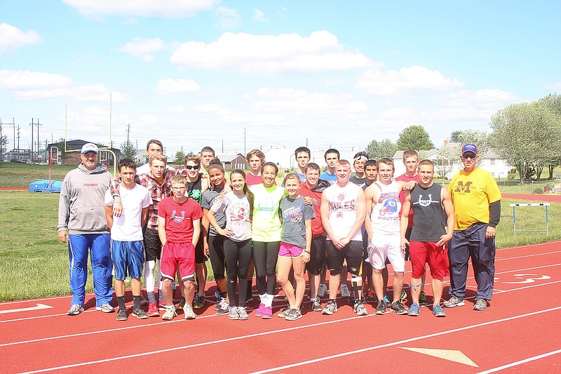 California High School Head Track Coach Rick Edwards, at far left, with members of the CHS varsity track team and assistant coach Rich Matzes, at right.  
