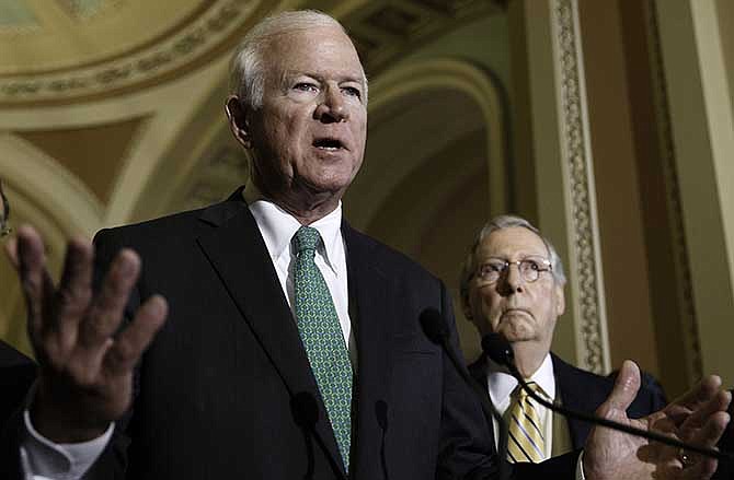 Senate Intelligence Committee Vice Chairman Sen. Saxby Chambliss, R-Ga., left, accompanied by Senate Minority Leader Mitch McConnell of Ky., disparage the Obama administration's decision to swap Army Sgt. Bowe Bergdahl, the only American soldier held captive in Afghanistan, in exchange for high-level Taliban militants detained at Guantanamo Bay, Tuesday, June 4, 2014, during a news conference on Capitol Hill in Washington. 
