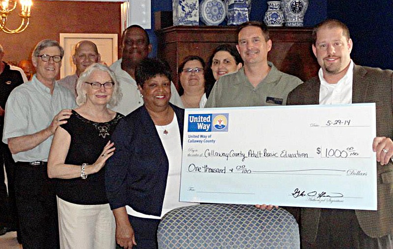 Central Missouri Community Action was awarded a $1,000 community enhancement grant to Central Missouri Community Action during the United Way Victory Celebration May 29 at 2013 honorary United Way campaign chairs Barney and Jane Forsythe's home. Back row, from left: Barney Forsythe, Tad Dobyns, Cliff Nevins, Sharon Lynch, Anne Johnson. Front row: Jane Forsythe, Lois Nevins, Darin Preis and Glenn Harris.