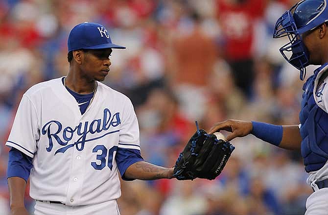 Kansas City Royals starting pitcher Yordano Ventura (30) takes a ball from catcher Salvador Perez, right, after giving up a run in the fourth inning of a baseball game against the St. Louis Cardinals at Kauffman Stadium in Kansas City, Mo., Thursday, June 5, 2014.