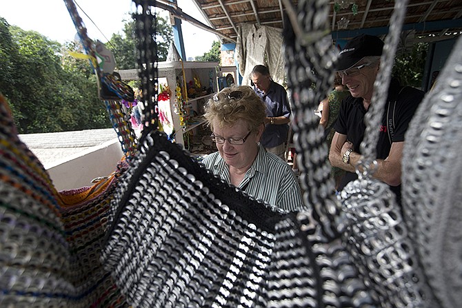 Foreigners shop for handcrafts during a tour in Rio de Janeiro, Brazil. The dizzying prices are referred to here as the Custo Brasil, or Brazil Cost, the mixture of high taxes and steep import tariffs, combined with bad infrastructure, a dose of inefficiency and a thick shot of bureaucracy. 