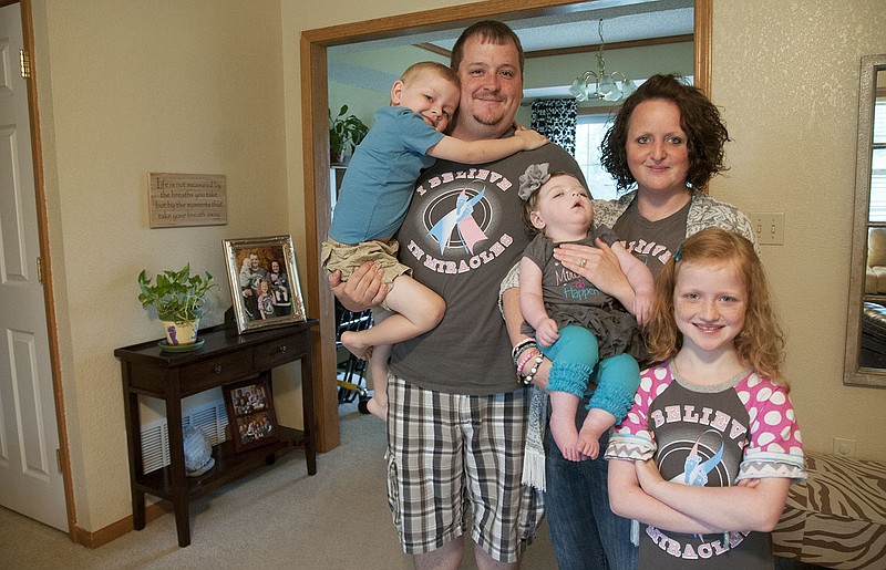 The Turner family stands for a photo inside their Lake Mykee home Saturday morning. A June 14 fundraiser will benefit the youngest in the Turner family, Milleigh, who doctors diagnosed with spastic quad cerebral palsy.