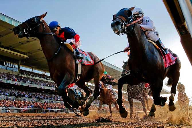 Tonalist, left, with Joel Rosario up edges out Commissioner with Javier Castellano up to win the 146th running of the Belmont Stakes horse race, Saturday, June 7, 2014, in Elmont, N.Y.