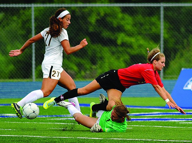 Jefferson City forward Natalie Vance gets tangled up with St. Teresa goalkeeper Alexis Batliner during Friday's Class 3 semifinal at Blue Springs.