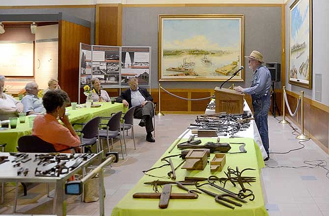 Dr. Jim Price discusses tool-making and shows off some of the traditional tools in his own collection during a talk
entitled "Ozark Ingenuity and Tool-making" at the Missouri State Archives on Saturday. Price is an archaeologist and anthropologist who grew up in Ripley County and studies the culture of the Ozarks.