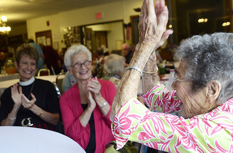 Maxine Farber joins in the applause after her friends sing "Happy Birthday" to her at Hyder Apartments Sunday afternoon. She celebrated her 100th birthday.