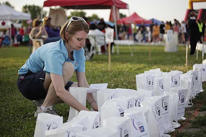 Christa Cain organizes luminaries' that are dedicated to her father during the Cole County Relay For Life Friday, June 6 at the Jaycee Fairgrounds.  Cain's father, Joe Herigon, died of lung cancer in 2010 but was supported by his family during the event. 