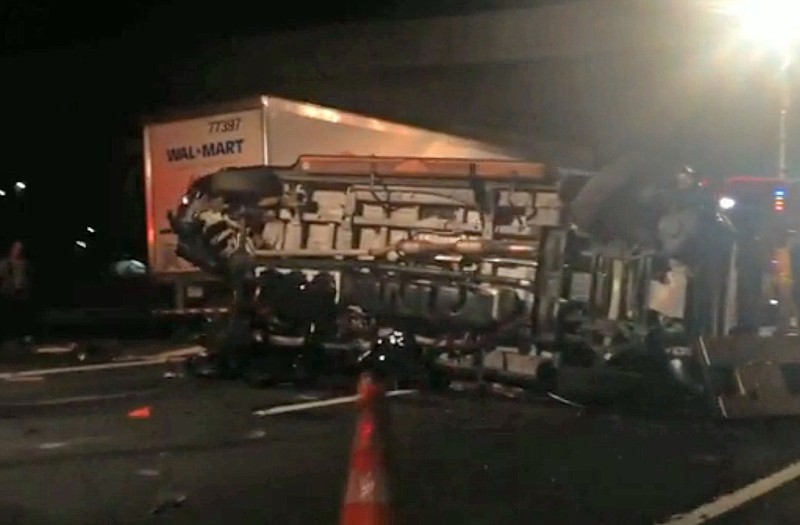 In this image from video the limousine bus carrying Tracy Morgan and six other people lies on it's side early Saturday morning on the New Jersey Turnpike. Morgan remained hospitalized as state and federal officials continued their investigation of the six-vehicle crash on the New Jersey Turnpike that took the life of a Morgan friend and left two others seriously injured, authorities say.