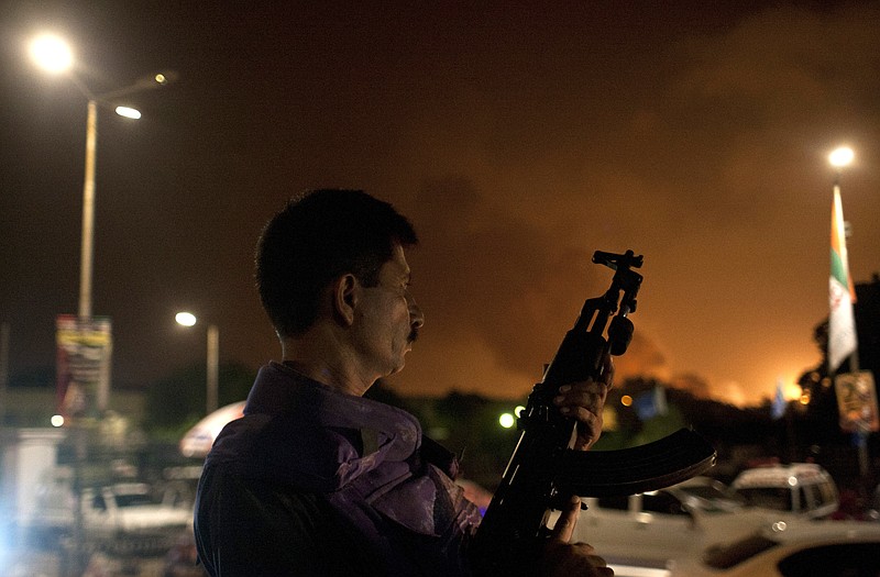 A Pakistani soldier takes position at Jinnah International Airport  where security forces are fighting with gunmen who disguised themselves as police guards and stormed a terminal used for VIPs and cargo, Sunday night in Pakistan. The airport attack still was ongoing early Monday in Karachi, a sprawling port city on the southern coast of Pakistan, although officials said all the passengers had been evacuated. 