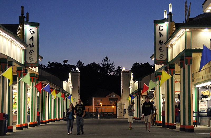 A few people walk an empty midway at Playland amusement park in Rye, N.Y. Playland, a collection of modest coasters, rides and attractions that evokes a simpler time and even holds a place in Hollywood history, is in trouble. The 86-year-old Art Deco landmark north of New York City is the nations largest government-run amusement park, and its been a money loser for suburban Westchester County for years.