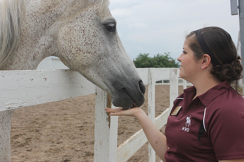 Graduate Assistant Bailey McCallum and one of the many horses she helps take care of over the summer at William Woods University.