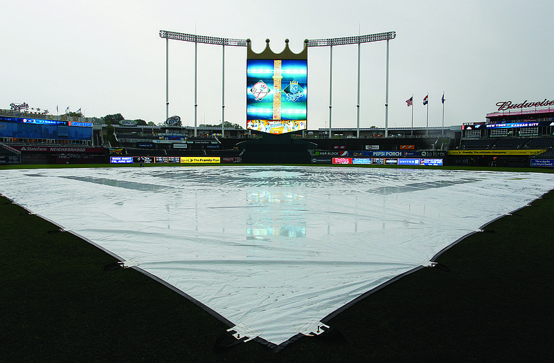 A tarp covers the infield at Kaufmann Stadium after Monday's game was called between the Royals and Yankees.