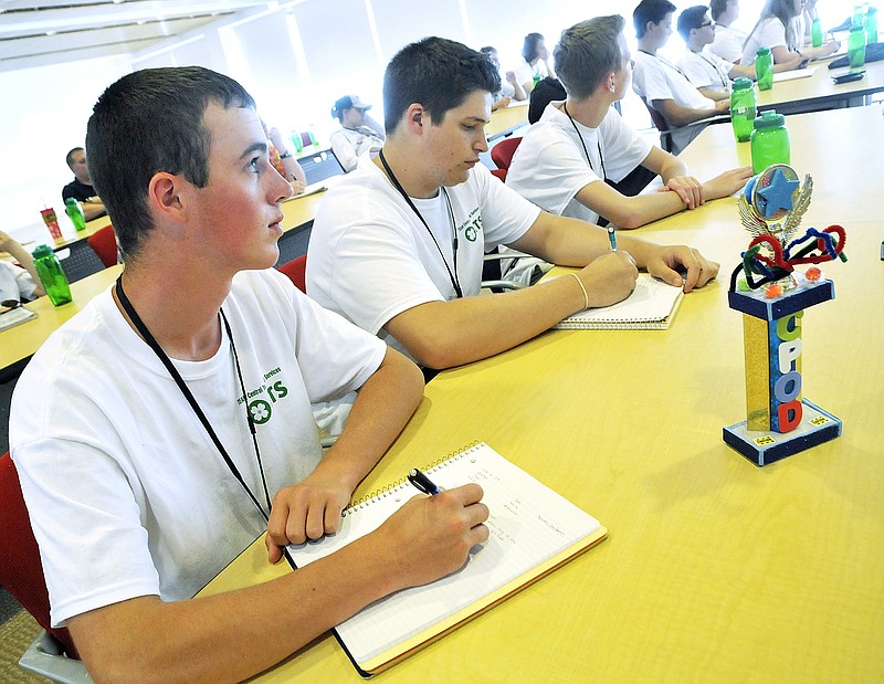 Several Missouri high school students have convened in Jefferson City for the Computer Professions on Demand (CPoD) event hosted through Linn State Technical College. From left, Drew Angerer of Fatima High School and Matt Spencer of Linn High School takes notes as they take in the information provided by Jill Hansen, senior vice president of application development at Central Technology Services.