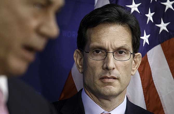 House Majority Leader Eric Cantor of Va., listens at right as House Speaker John Boehner of Ohio, during a news conference on Capitol Hill in Washington, Tuesday, June 10, 2014.