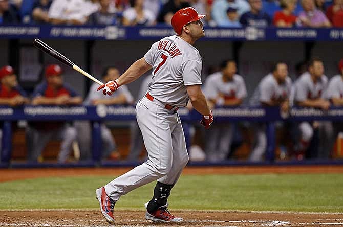 St. Louis Cardinals' Matt Holliday follows through on his solo home run during the sixth inning of a baseball game against the Tampa Bay Rays, Tuesday, June 10, 2014, in St. Petersburg, Fla. 