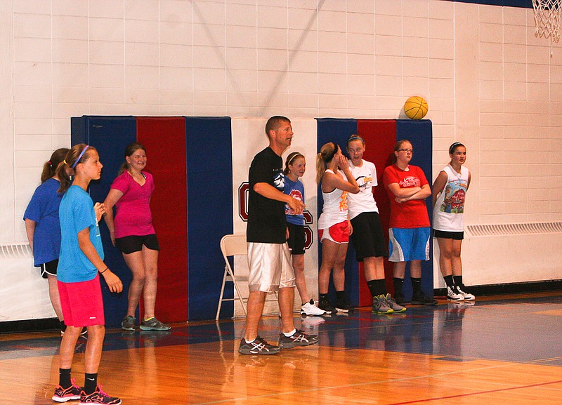 Coach Brian Lawson, center, instructs seventh and eighth-grade girls at the California Middle School Lady Pintos Basketball Camp June 3 at the CMS gym.  
