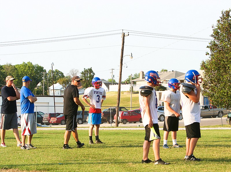 Head Coach Marty Albertson, center, instructs Pintos at the annual California High School Pintos Football Camp June 3 at Riley Field. 
