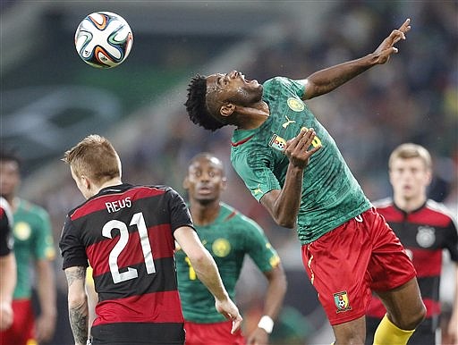 Cameroon's Alexandre Song, right, and Germany's Marco Reus challenge for the ball during a friendly World Cup preparation soccer match between Germany and Cameroon in Moenchengladbach, Germany on Sunday.