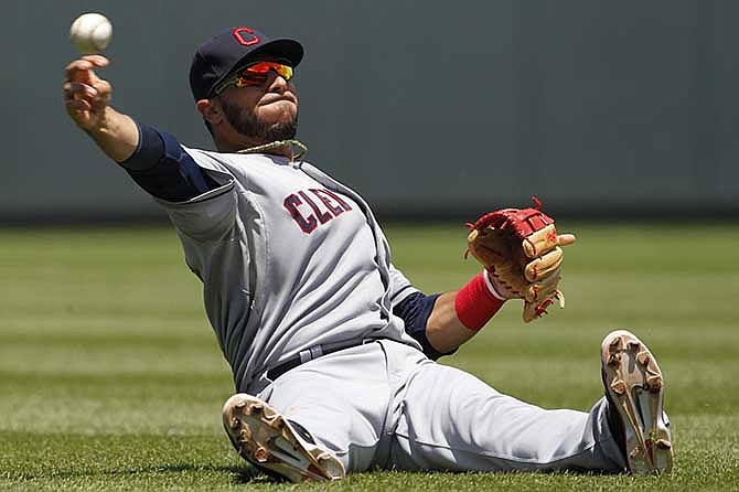 Cleveland Indians shortstop Mike Aviles throws to home plate after catching a fly ball in the third inning of a baseball game against the Kansas City Royals at Kauffman Stadium in Kansas City, Mo., Wednesday, June 11, 2014. Kansas City's Alcides Escobar scored from third on the sacrifice fly.