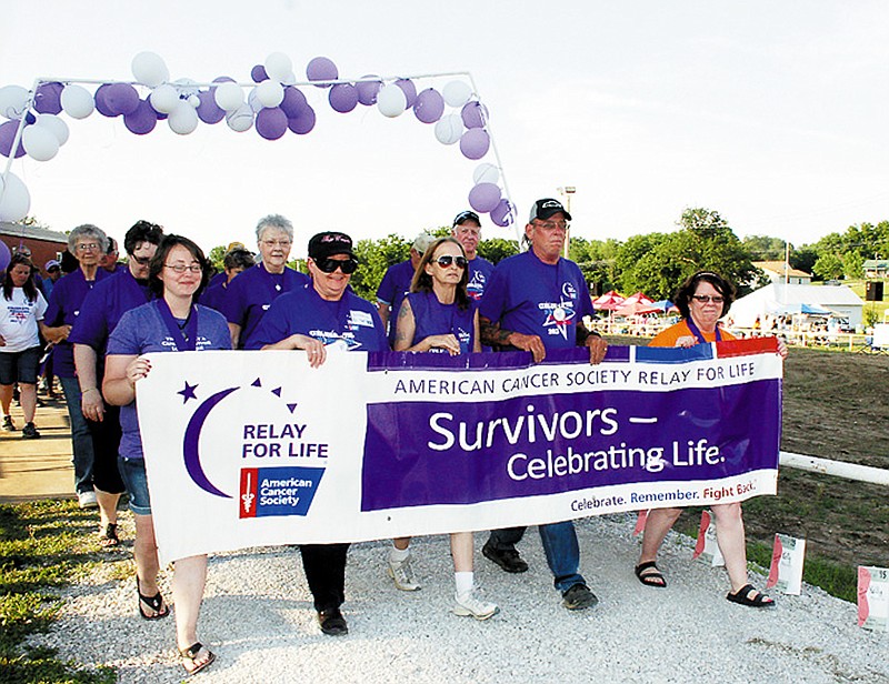 Cancer survivors will walk the survivor lap in the opening ceremony of the American Cancer Society 14th Annual Relay For Life of Moniteau County Friday at the Moniteau County Fairgrounds, California, just as survivors did at last year's Relay For Life, above, June 14, 2013.  
