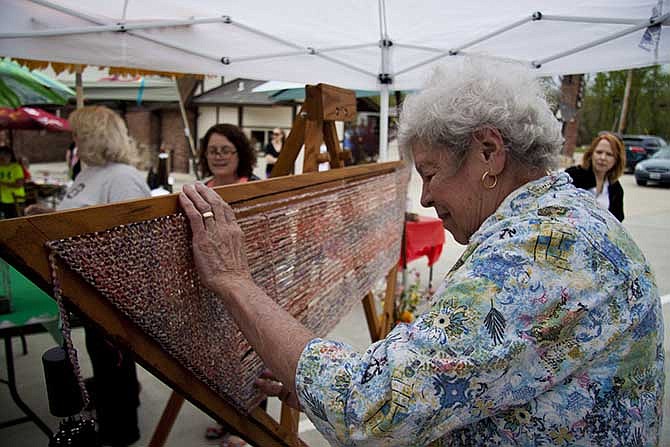 Bobbie Ferrier weaves a shawl on a triangular frame, left. Bertolotti and Ferrier, along with other artists, will be doing demonstrations at the Summer Fair Saturday.