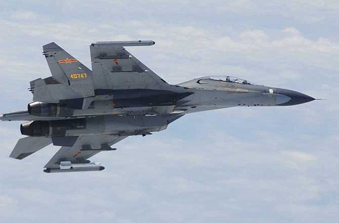 In this undated photo released by Japan Ministry of Defense, Chinese SU-27 fighter plane is shown. China and Japan are blaming each other for a close encounter between military jets over the East China Sea. China's defense ministry says Japanese F-15 fighters followed a Chinese TU-154 plane on regular patrol Wednesday, June 11, 2014 and got as close as 30 meters (100 feet). Japanese Defense Minister Itsunori Onodera said Wednesday that two Chinese SU-27 fighters had posed a danger to Japanese aircraft by flying near them.