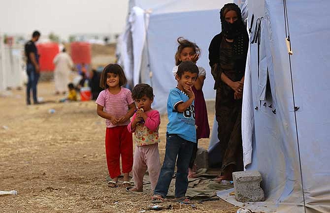Iraqi refugees from Mosul at Khazir refugee camp outside Irbil, 217 miles (350 kilometers) north of Baghdad, Iraq, Thursday, June 12, 2014. The Islamic State of Iraq and the Levant, the al-Qaida breakaway group, on Monday and Tuesday took over much of Mosul in Iraq and then swept into the city of Tikrit further south. An estimated half a million residents fled Mosul, the economically important city.