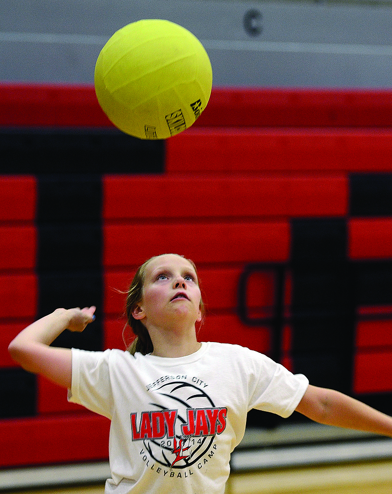 Landrey VanOverschelde serves the ball during a session of the Jefferson City Lady Jays volleyball camp Thursday at Fleming Fieldhouse.