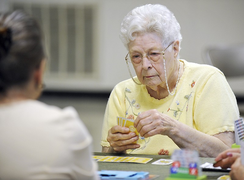 Kay Gunter, a member of the Mid-MO Bridge Club, plays her card during a game Monday at the Knights of Columbus Hall in Jefferson City. The group plays Monday afternoon and Wednesday evenings at the Jefferson City Senior Center in the Capital Mall.