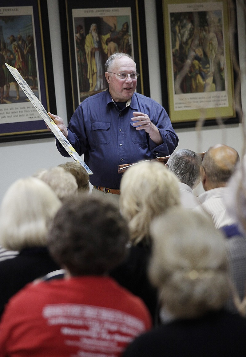 Jim Hofmann points to various newspaper clippings and photos as he talks about Osage City and its history at the "Getting to Know Our Communities" event hosted by the Cole County Historical Society Thursday at St. John's Lutheran Church.