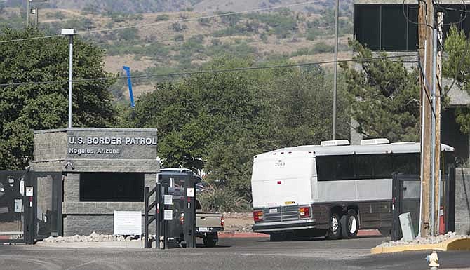 A bus carrying children arrives to a border patrol facility in Nogales, Ariz., Saturday, June 7, 2014. Arizona officials said that they are rushing federal supplies to a makeshift holding center in the southern part of the state that's housing hundreds of migrant children and is running low on the basics. (AP Photo/The Arizona Republic, Patrick Breen)