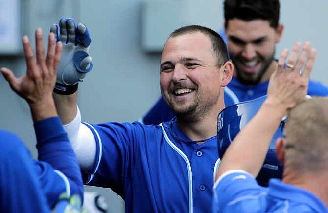 Kansas City Royals' Billy Butler smiles as he celebrates with teammates in the dugout after hitting a 2-run home run during the ninth inning of a baseball game against the Chicago White Sox in Chicago on Saturday, June 14, 2014.