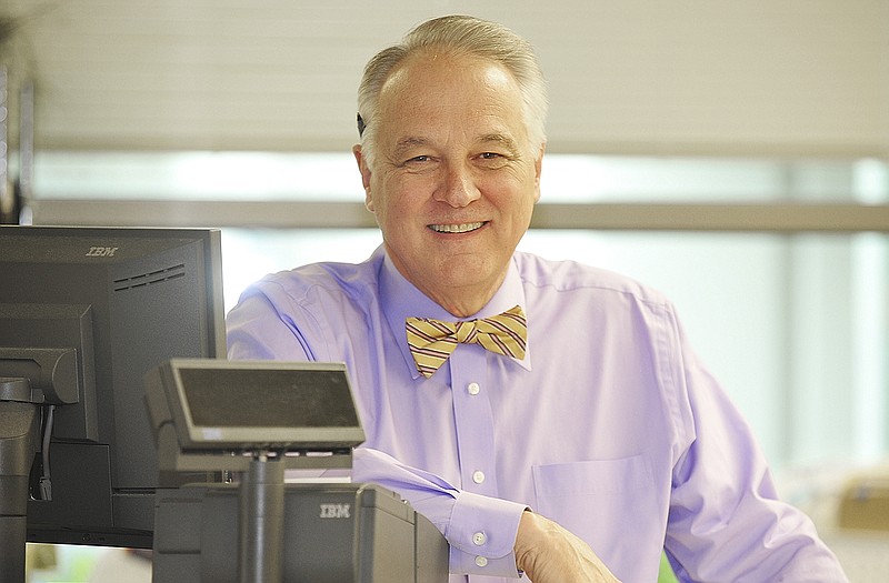 JCMG's popular pharmacy technician Gary Dey stands at the counter.