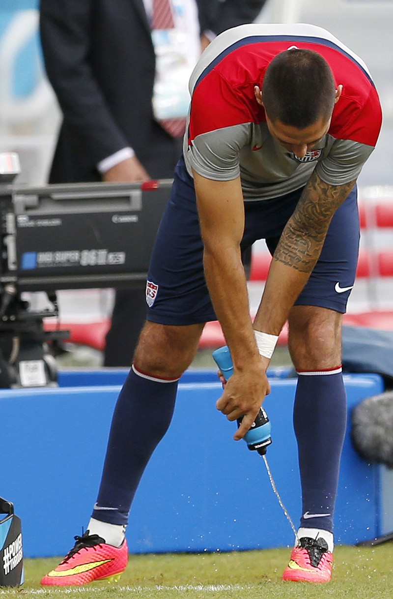 Clint Dempsey of the United States sprays water on his shoes during practice Sunday at the Arena das Dunas in Natal, Brazil.