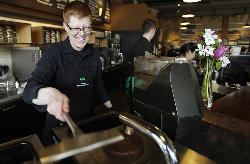 Starbucks barista Linsey Pringle prepares a cup of coffee at a Starbucks Corp. store in Seattle. Starbucks on Monday announced a new partnership with Arizona State University to make online degrees available to its 135,000 U.S. employees who work at least 20 hours a week.