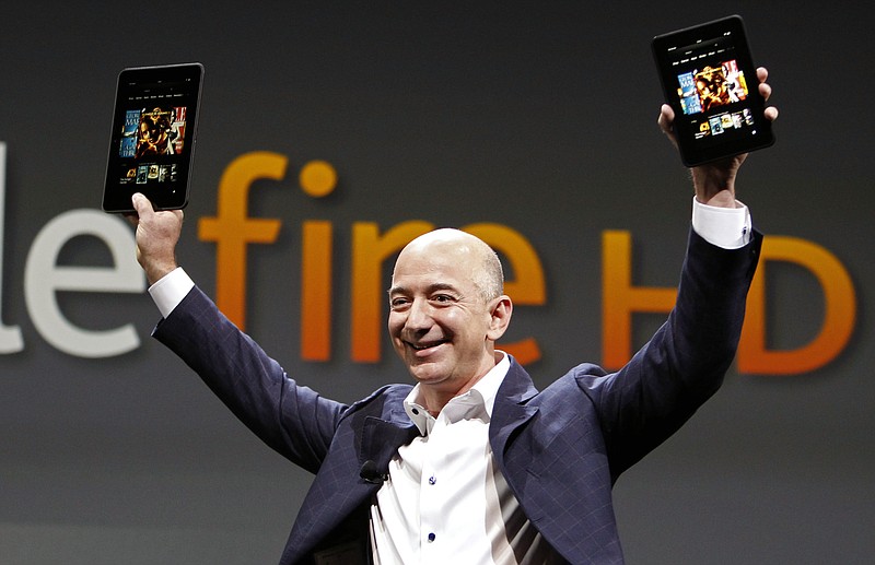 In this file photo, Jeff Bezos, CEO and founder of Amazon, introduces the Amazon Kindle Fire during an event in Santa Monica, Calif. Amazon is hosting a launch event Wednesday in Seattle, and media reports indicate the product will be an Amazon phone - perhaps one with multiple cameras that can produce 3-D photos.