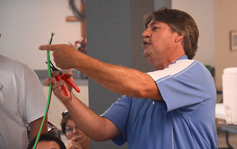 Co-Mo Education Specialist Keith Mueller tells 4-H campers at Heit's Point how long to cut the wires on the extension cords they are building during his June 12 visit. The camp welcomed children from across central Missouri, including Cooper County.Â 
