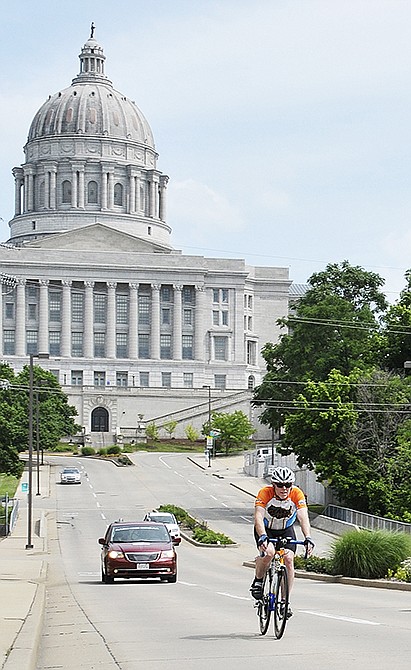 A rider from Team Bike the US for MS makes his way westward on West Main Street Wednesday afternoon shortly after leaving Checkpoint 33 at the Jefferson Street Conoco.