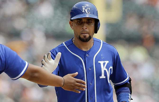 Kansas City Royals' Omar Infante is congratulated after hitting a solo home run during the fifth inning of a baseball game against the Detroit Tigers in Detroit, Wednesday, June 18, 2014.