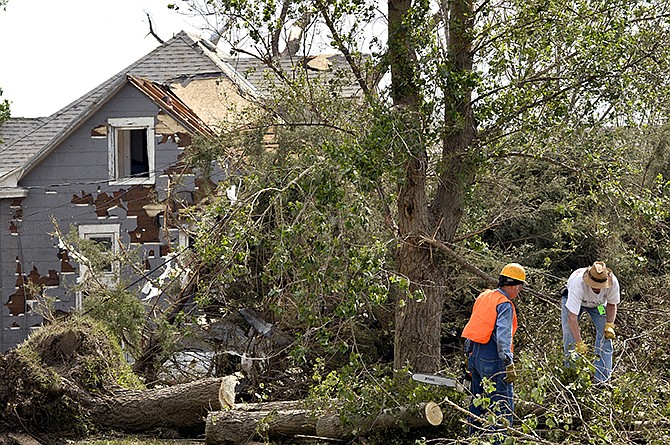 Workers clean up debris from a property in Pilger, Nebraska. Wednesday was the first day volunteers were allowed into town to help with cleanup following Monday's storm. The storm spawned at least four tornadoes, and killed two people in the Pilger area. 